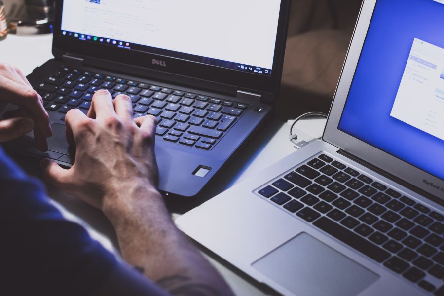 a person typing on a computer to receive website management support