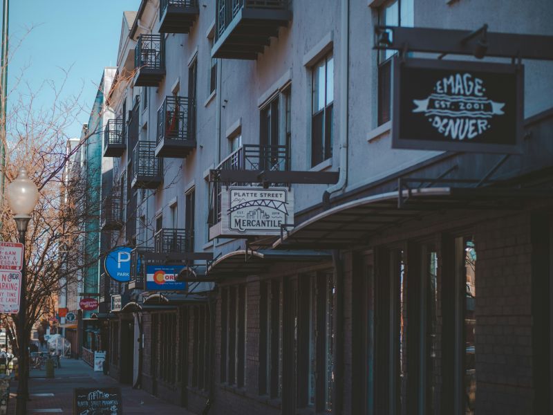 a street lined with signs of local businesses