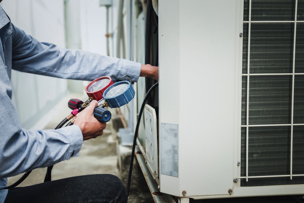 HVAC digital marketing header a technician checks refrigerant in an HVAC system